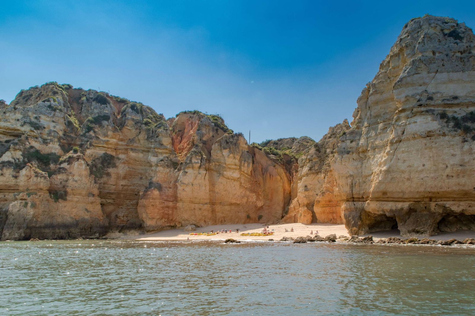 Praia da Balança secret cove surrounded by golden cliffs near Lagos