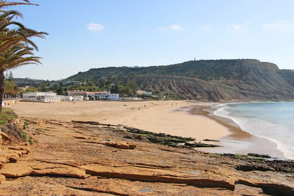Praia da Luz beach with Rocha Negra black rock in the Algarve