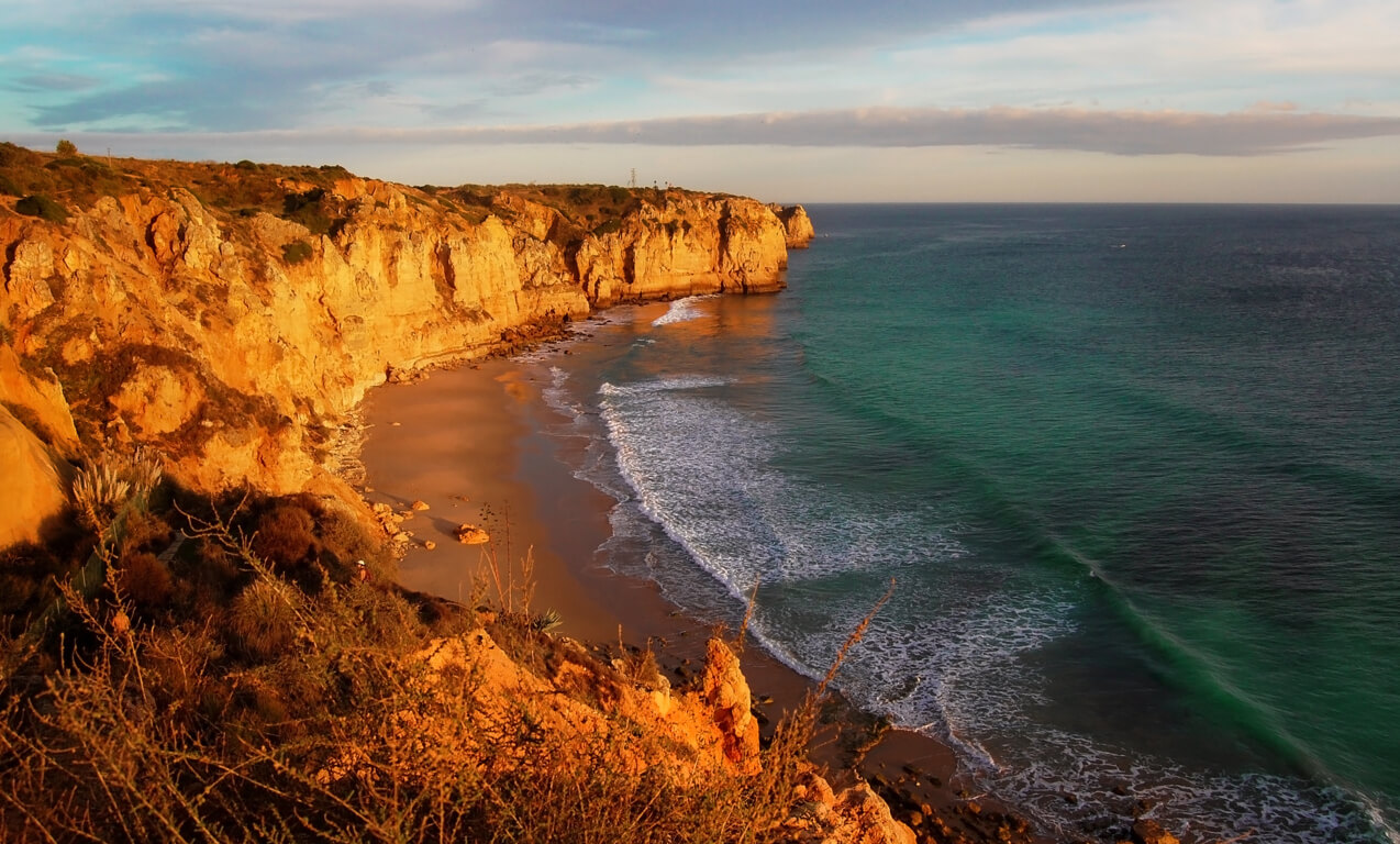 Praia do Canavial wild beach with tall ochre cliffs near Lagos