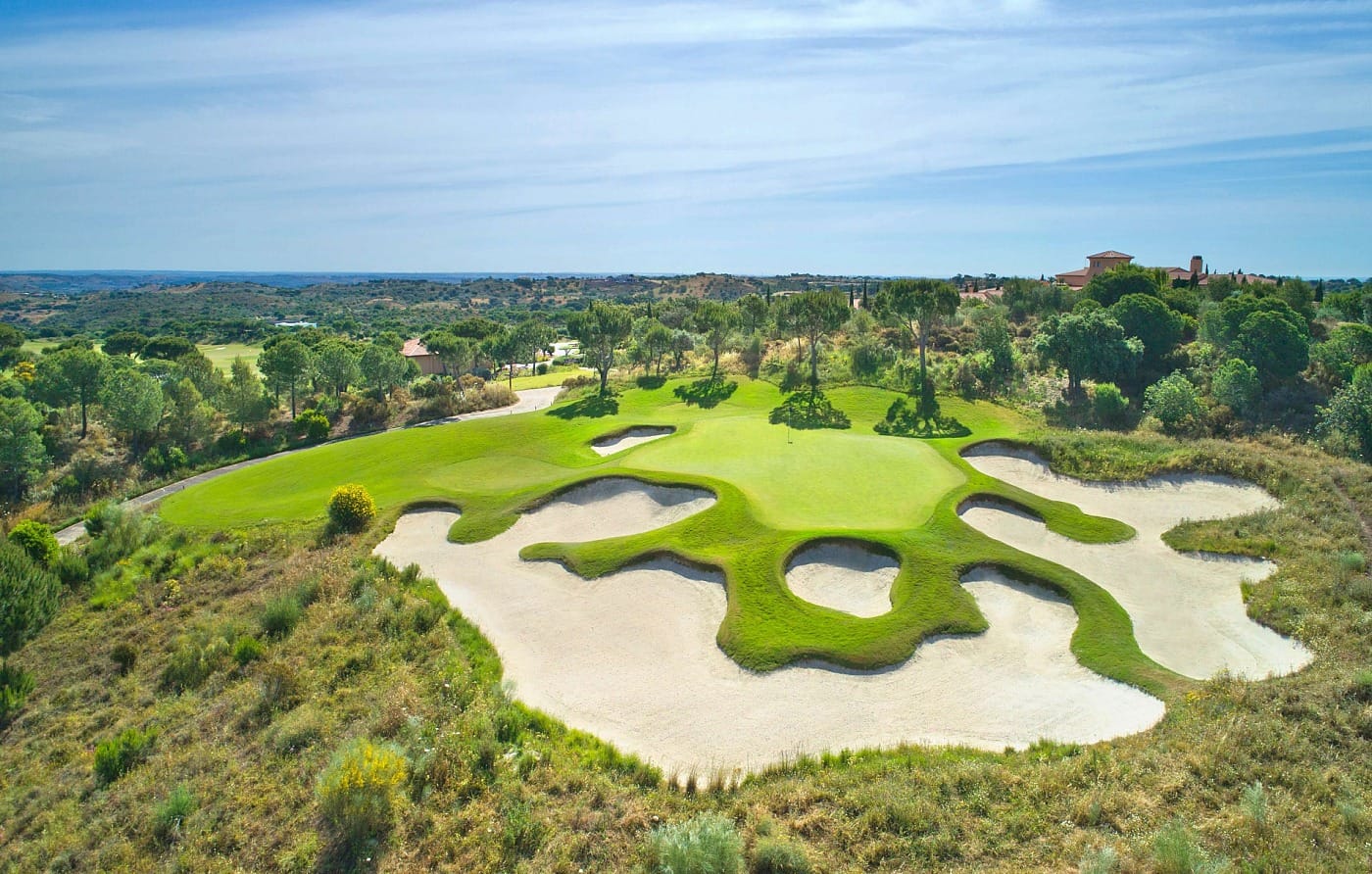 Monte Rei Golf Course distinctive bunker complex surrounded by native Algarve vegetation