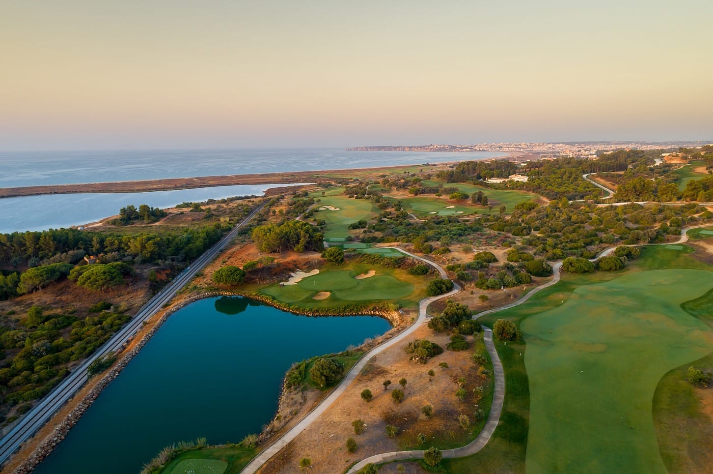 Aerial view of Palmares Golf Course at sunset overlooking the Bay of Lagos