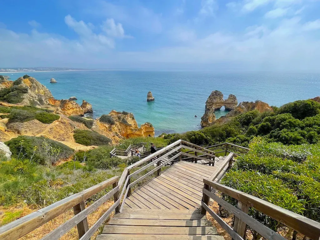 Aerial view of Lagos old town with white buildings, terracotta rooftops and coastline, Algarve Portugal