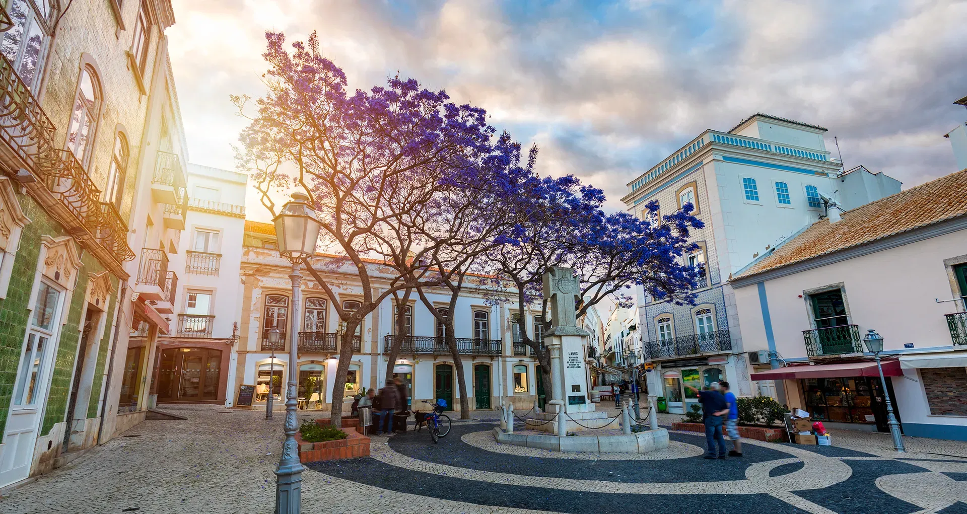 Wooden boardwalk stairs leading down to Ponta da Piedade with golden cliffs and turquoise sea in Lagos, Portugal